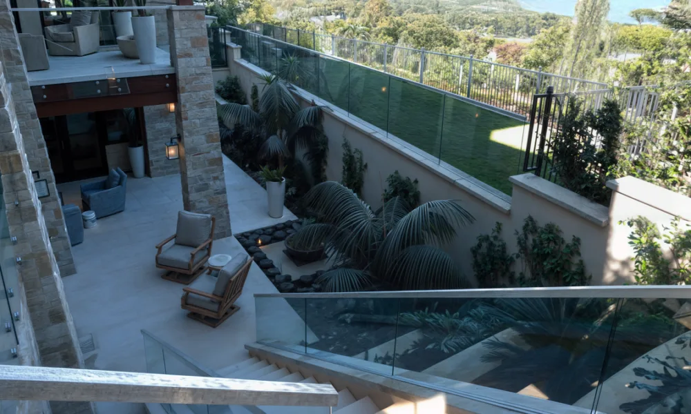 Frameless base-shoe railing systems reduce visible hardware, but their design must coordinate glass composition, slab anchoring, waterproofing and drainage