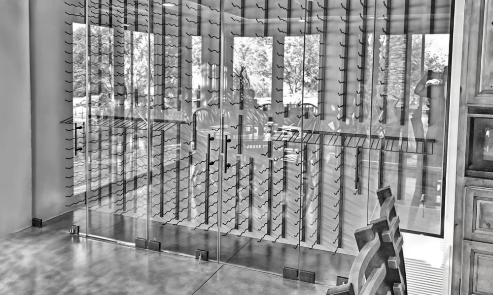 Glass and aluminum systems can help define a wine cellar within residential or commercial interiors while supporting visibility, access and architectural integration.