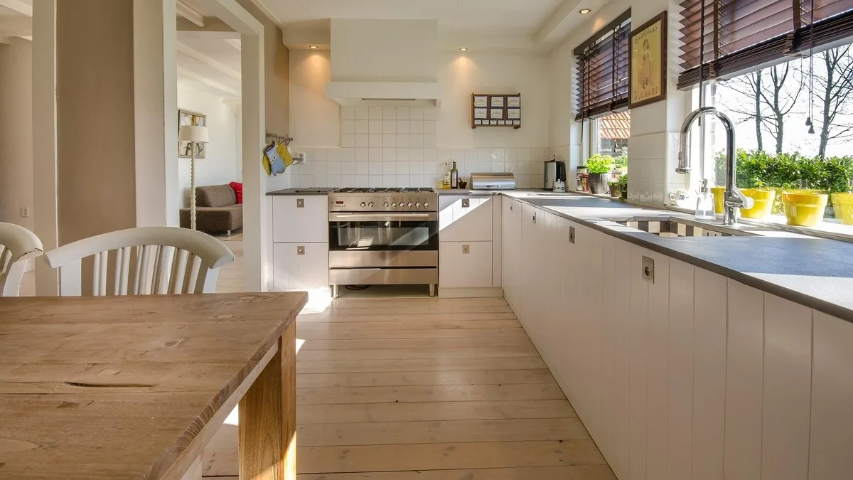 Pairing a picture window with an operable section brings daylight and ventilation into the kitchen while allowing the opening portion to sit where it is easiest to use