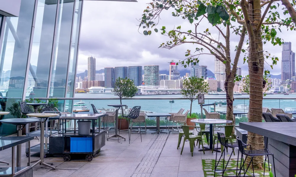 Sliding and bifold glass doors use different panel movements and storage arrangements to create wide openings between interior and rooftop spaces.
