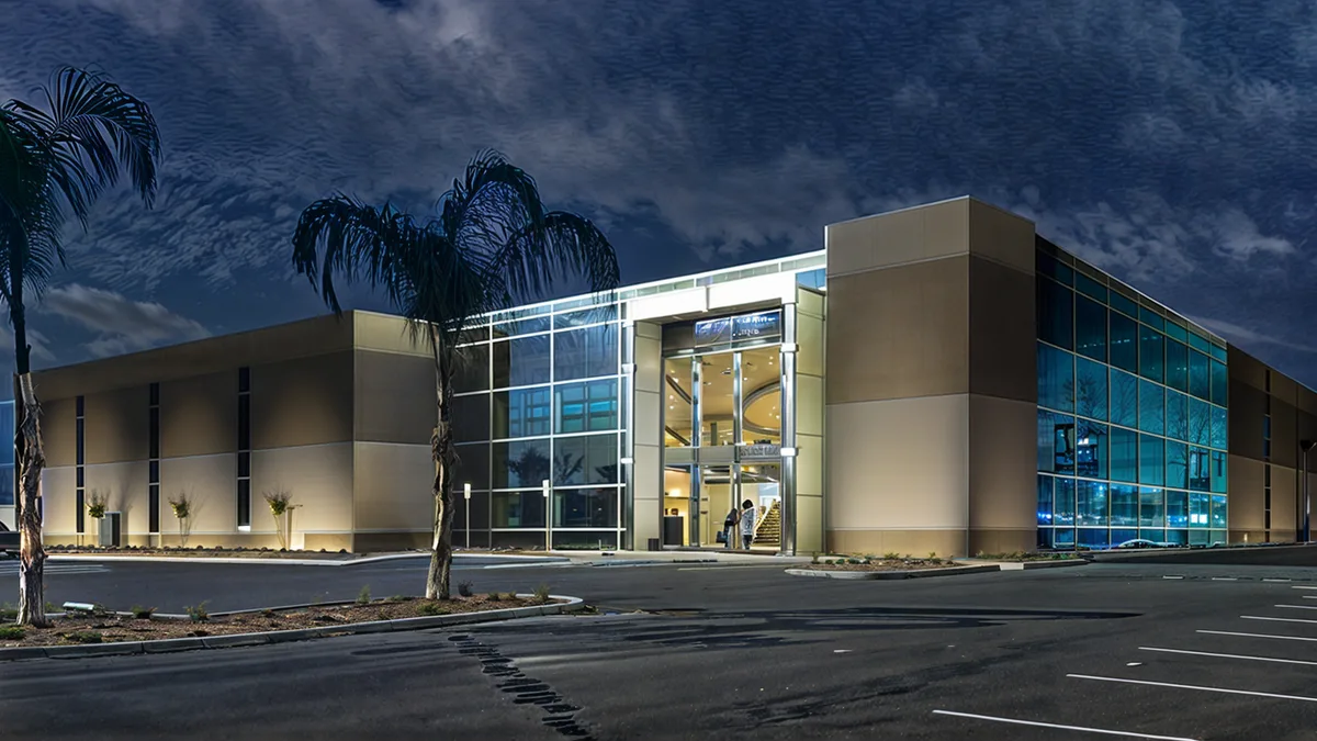 Modern aluminum window system with fixed, casement and awning configurations installed in a contemporary interior.